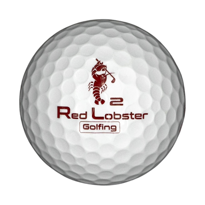 Lobbie PURE Golfball in Weiß mit rotem Red Lobster Golfing Logo und Ziffer 2, freigestellt