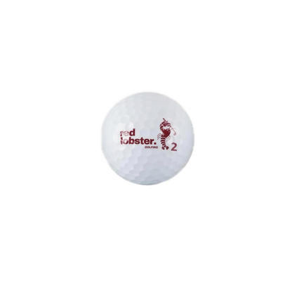 Weißer Lobbie PURE Golfball mit Red Lobster Golfing Logo, Hummer-Motiv und Spielnummer 2 vor weißem Hintergrund